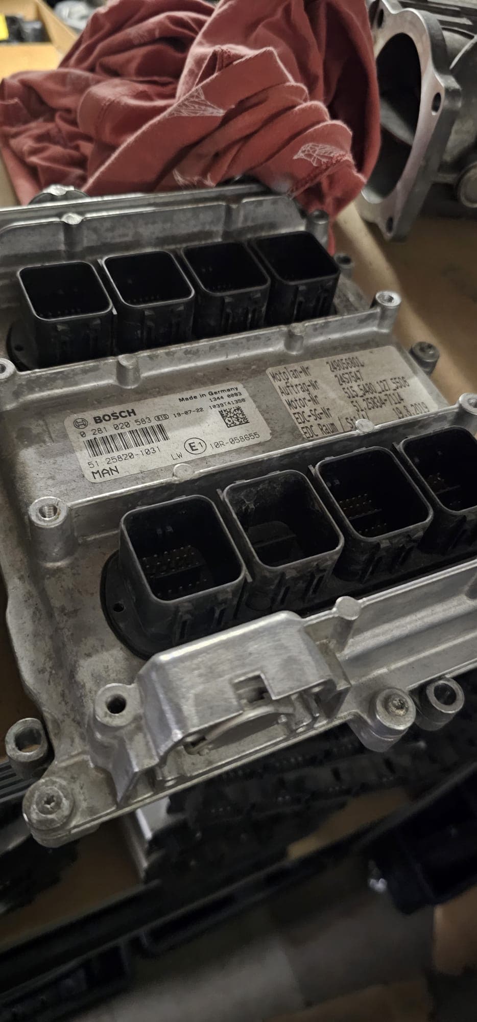 Silver Bosch engine control unit featuring multiple black electrical connector ports and identification labels.